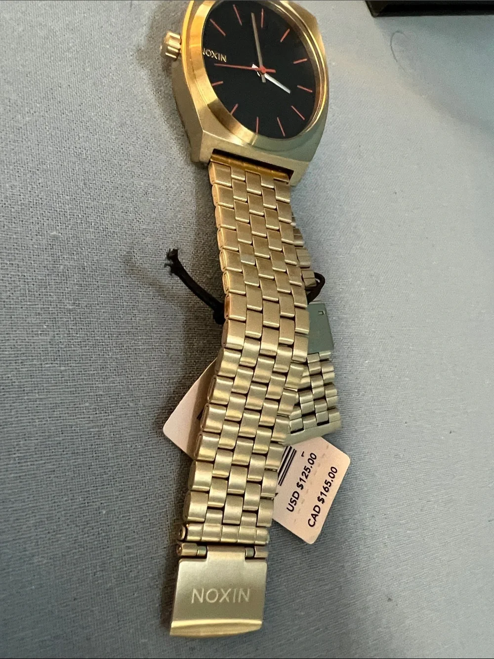 Nixon Gold Watch with Black Dial and Red Accents, Time Teller Model